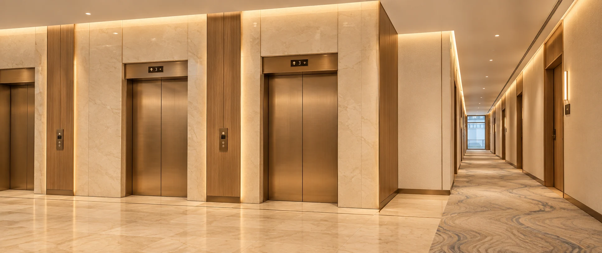 Lift lobby · View 01Bronze portals and a clear corridor connection support intuitive wayfinding.
